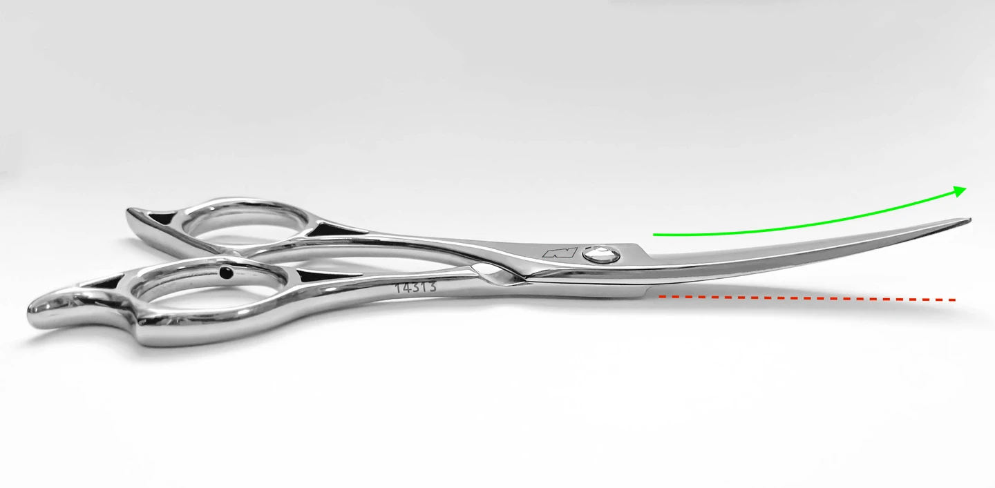 a silver left handed scissor with a black "N" logo laying flat on a white background showing the blade curving upwards.