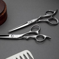 silver right handed scissors with grey "N" logo  on a grey background