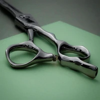 silver colored right handed hair scissor with black "N" logo showing the curves of the handles