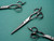 silver colored right handed hair scissor with black "N" logo on a green background