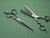 silver right handed scissors with black "N" logo and 26teeth on one blade on a green backgorund