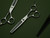 silver right handed scissors with black "N" logo and 35 teeth on one blade on a green background