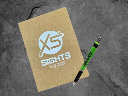 notebook and green pen