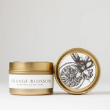 Orange Blossom Soy Wax Candle Tin - A stylish, travel-friendly 4 oz metal tin candle with minimalist branding. The lid features a clean, elegant design with citrus-inspired accents, while the soft soy wax inside is centered by a natural cotton wick. Compact yet refined, it’s perfect for modern spaces, gift bags, or self-care moments.