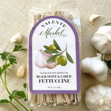 Black Olive & Garlic Fettuccine - A bundle of artisanal fettuccine noodles with dark flecks of black olive and garlic, elegantly packed in clear cellophane with a rustic label. The strands are slightly textured, capturing the essence of handmade quality. A visual feast of bold, savory flavor. Black Olive & Garlic Fettuccine - A bundle of artisanal fettuccine noodles with dark flecks of black olive and garlic, elegantly packed in clear cellophane with a rustic label. The strands are slightly textured, capturing the essence of handmade quality. A visual feast of bold, savory flavor.