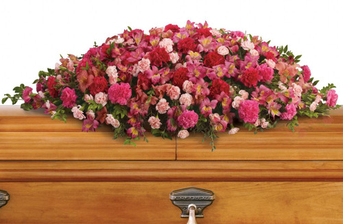 The sumptuous floral tribute for a casket  includes dark pink alstroemeria, hot pink carnations, pink carnations and miniature light pink carnations accented with huckleberry and eucalyptus.