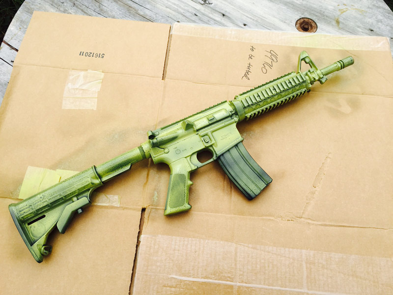 first coat green paint on black rifle