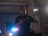 Police officer using SureFire Stiletto Pro flashlight during night patrol