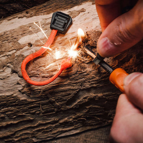 Exotac TinderZIP waterproof emergency tinder igniting with ferro rod during outdoor survival use