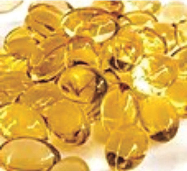 Image of numerous transparent yellow Pearl's Gold CBD soft gels.