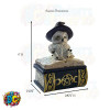 A snow owl figurine donning a witch's hat, perched atop a spell book, crafted as a small jewelry trinket box.