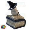 A snow owl figurine donning a witch's hat, perched atop a spell book, crafted as a small jewelry trinket box.