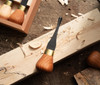 The #6 x 5/16" gouge that is included with the wood carving kit showing the cherry palm style handle, brass ferrule and cutting blade of the gouge.