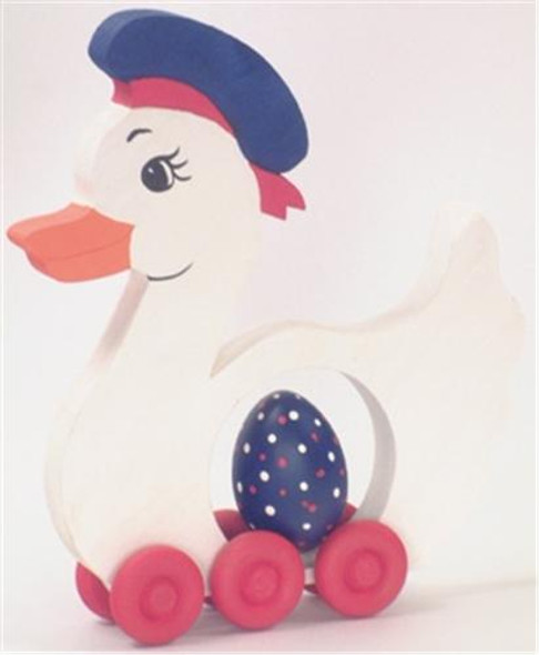 A finished boy duck from the Cherry Tree Boy Duck Woodworking plan featuring six wheels that roll the egg inside the duck as you push it along.  The duck is white with a red bandana, blue hat and orange beak.  The wheels are red and the egg has been painted a white polka dotted blue.