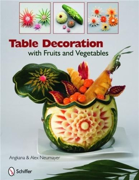 This photo features a watermelon with decorated fruit sitting on a table from the front cover of  Table Decorations With Fruits and Vegetables.