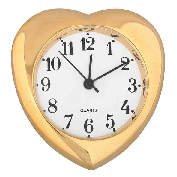 A heart shaped clock insert with a gold outer rim, white face and black Arabic numbers.