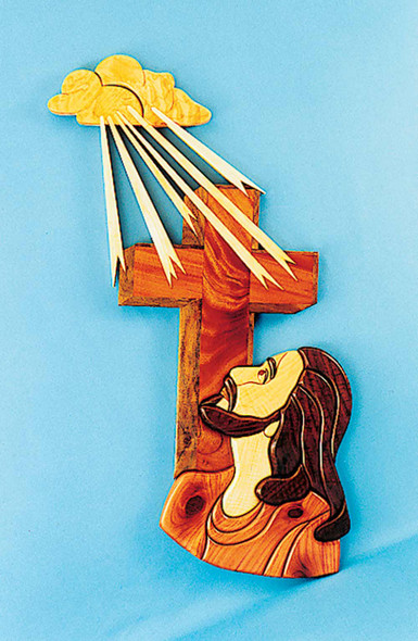 This photo show the scroll saw cut out finished and painted with Jesus holding a cross and sun rays shinning down on him using the Eyes on the Father Intarsia Plan