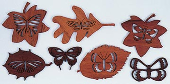 Finished butterflies resting on leaves made from wood using the scroll saw pattern.