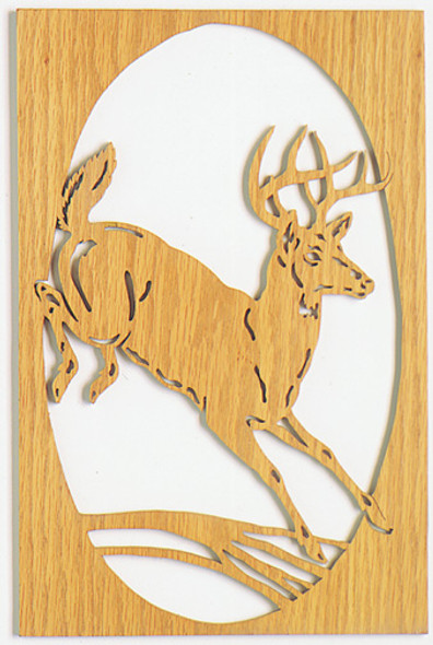 Scroll saw cut out of a Whitetail Deer jumping over a branch in a square frame. 
