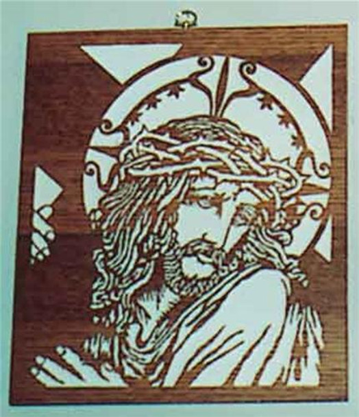 You are looking at the finished scroll sawn Jesus carring a cross with thorns around his head in a square frame. 