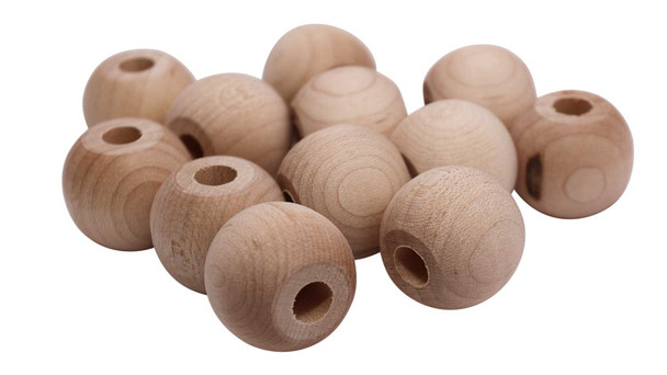 A group of wooden balls with holes in the center.
