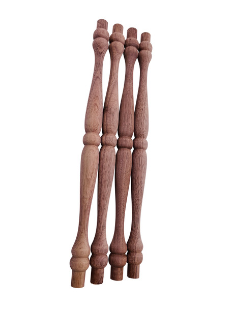Four large colonial style spindles in walnut.