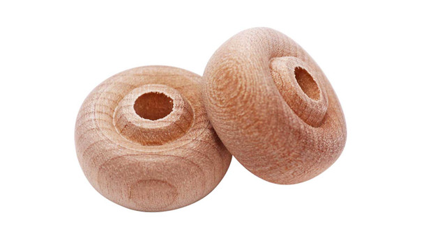 A pair of 1" thick faced wooden toy wheels showing the contours of the wheel and holes for the axles pegs.