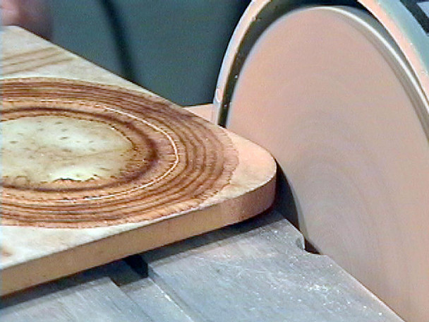  Sanding the corner of a board with a regular sanding disc.