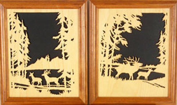 Finished and framed cut outs of the buck and doe in one frame and the bull elk and cow in the other frame. Both are surrounded by the forest overlooking the lake.
