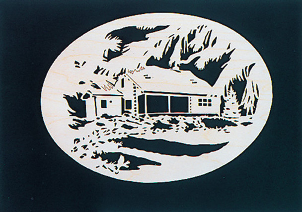 Silhouette of a finished scroll saw picture of a cabin in the deep woods.