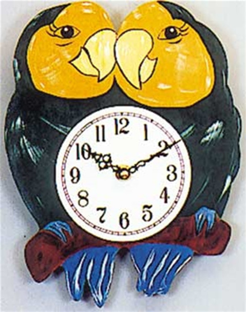 A finished scroll saw clock with two parrots and a clock in the center when using our Parrots Clock Scroll Saw Pattern.
