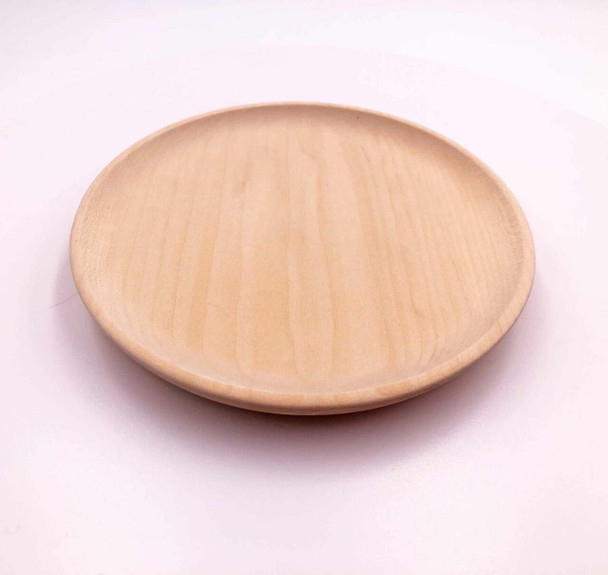 A flat basswood plate with scooped edges.