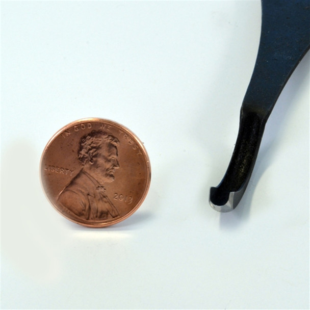 A 1/8 inch Flexcut  spoon gouge next to a penny to compare the depth of the curved blade.