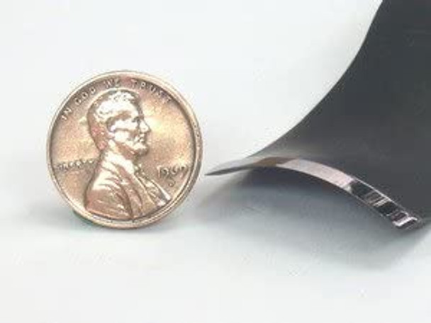 the edge of a #4 sweep back bent gouge  showing the size versus a penny.