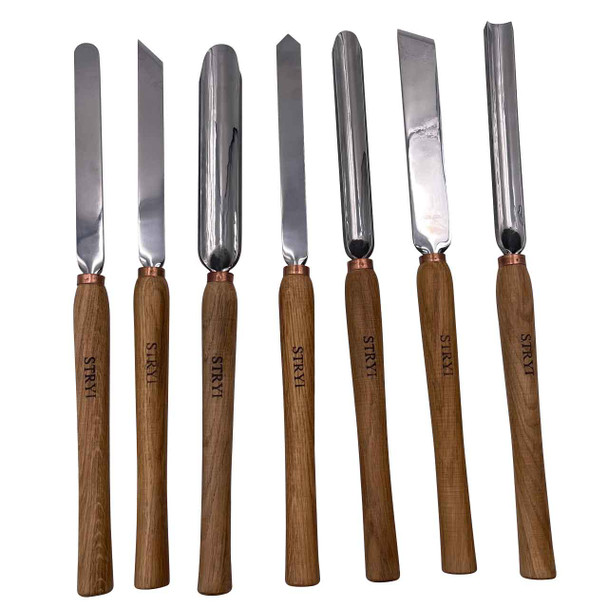 The individual turning tools that are included in the Stryi Woodturning 7 piece set.  The tools show their long oak handles and steel cutting surfaces.