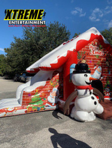 "Snowman house combo with a slide for kids at a holiday event"