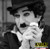 "Charlie Chaplin impersonator entertaining guests with silent comedy at a vintage-themed event"