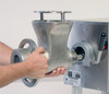 A grinder head being attached to a Pro-Cut #22 Meat Grinder