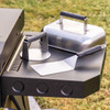 The Camp Chef Smash Burger Kit Resting on the side of a griddle ready to be used.