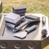 Life style shot of the Camp Chef Griddle Cleaning Kit on the side of a griddle.