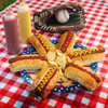 Walton's All American Hot Dog and Blogona seasoning on hotdogs with buns  on an American Picknick table