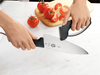 The Swiss Sharp Handheld Sharpener being used to sharpen a knife