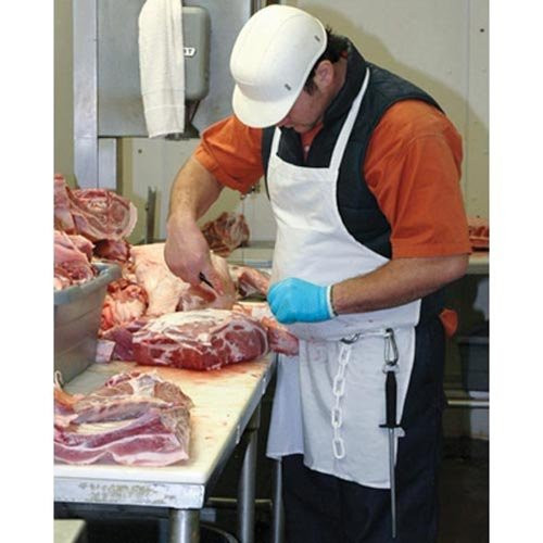 A man wearing a White Cotton Bib Apron while cutting a piece of meat