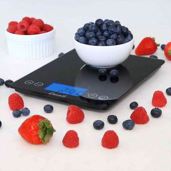 An Escali XL Glass Kitchen Scale being used to weigh a bowl of blueberries