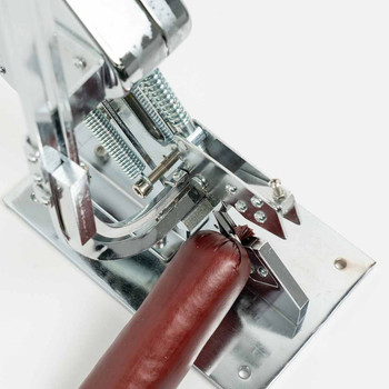 Bag and Casing Clipper in use clipping a filled sausage casing