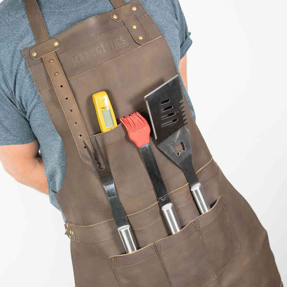 Pockets on the Meatgistics Leather Apron filled with cooking utensils