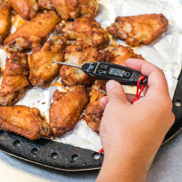 Digital Pen Thermometer in use making sure chicken wings are cooked