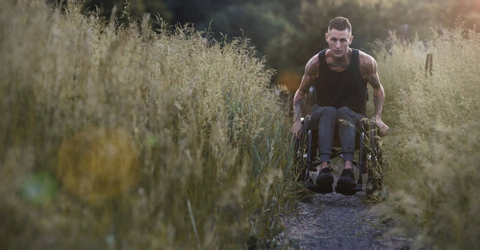 Man using a Quickie manual wheelchair on a path
