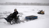 The Zoom All-Terrain Powered Vehicle in Snow hauling a sled
