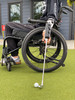 Side profile of person with C5 spinal injury using Swing Mate forearm mounted wheelchair golf aid.